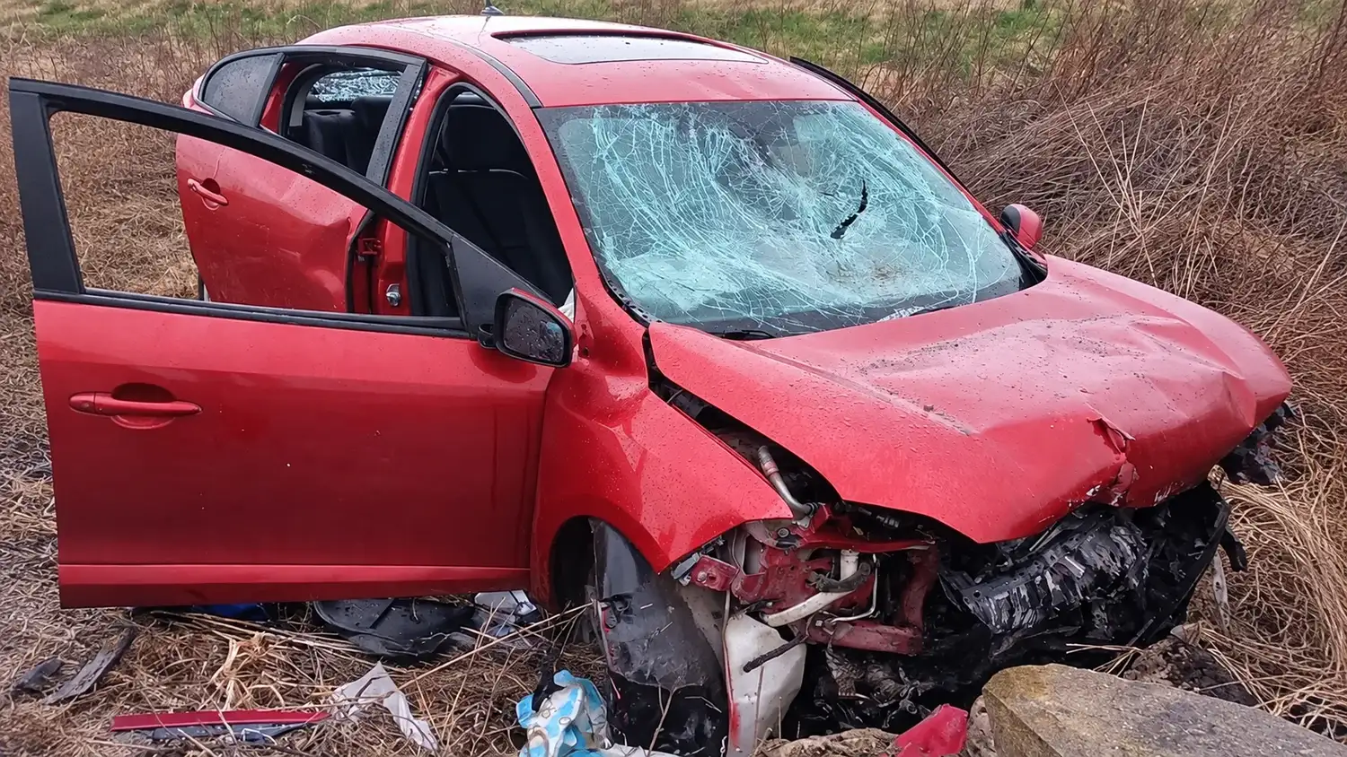 El vehículo rojo quedó con graves daños tras el fuerte impacto en la zona de Teodelina. El automóvil presenta el parabrisas destrozado y el frente destruido luego del accidente en el que fue asistido por un camionero que pasaba por el lugar.