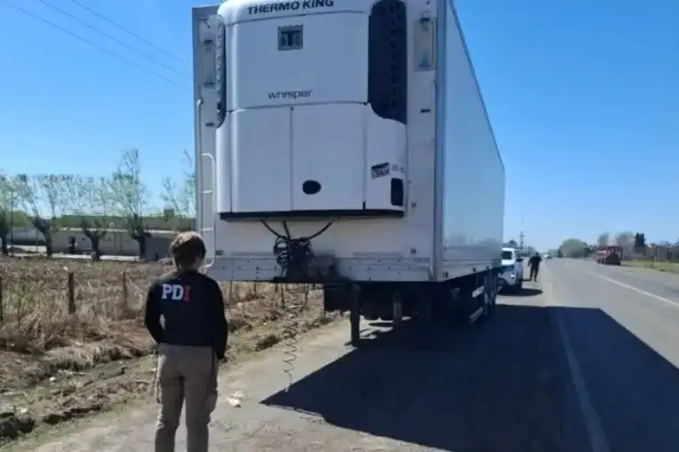 Personal de la PDI inspecciona el semirremolque térmico hallado en Firmat, tras el robo del camión ocurrido en Sanford.